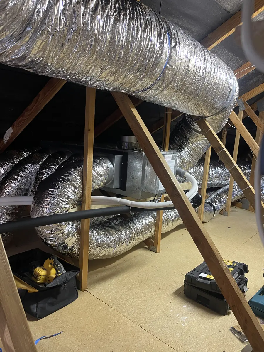 Insulated flexible ducting runs installed through a roof space