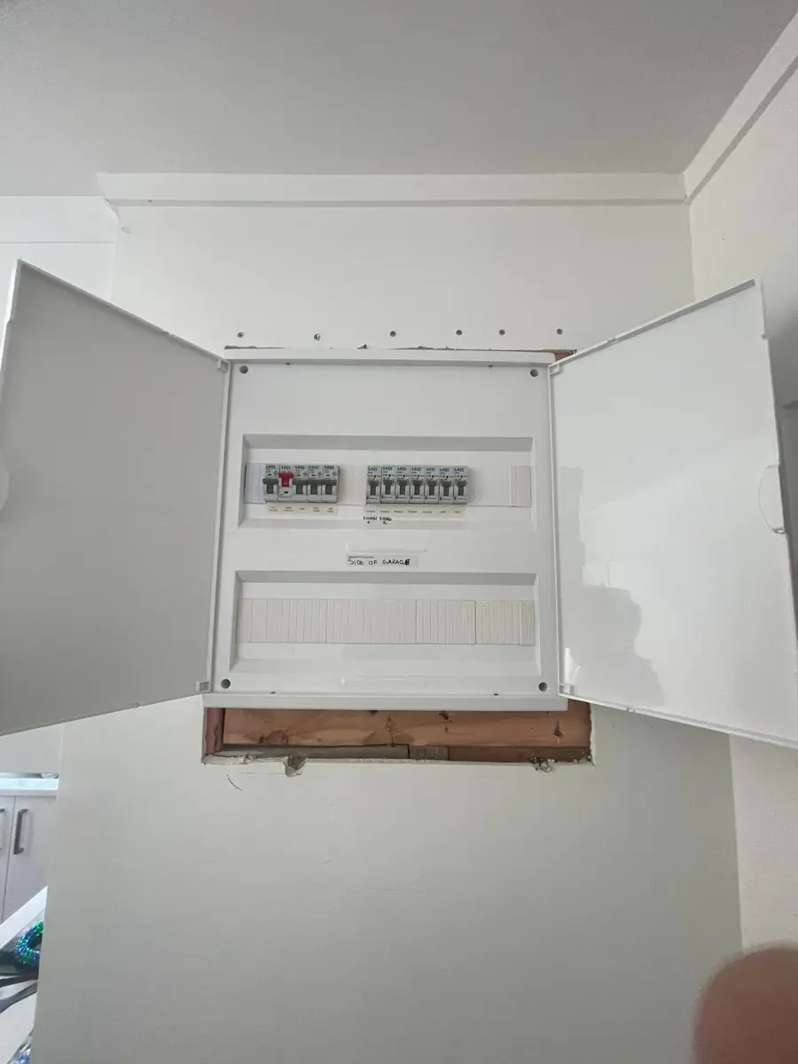 A new sub-board installed to feed a garage, doors open showing labelled breakers