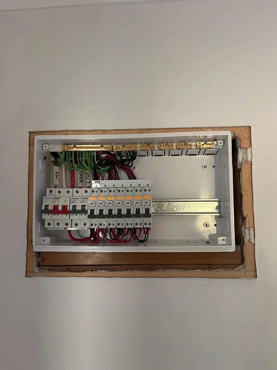 A new consumer unit installed and wired with the cover removed showing labelled circuits